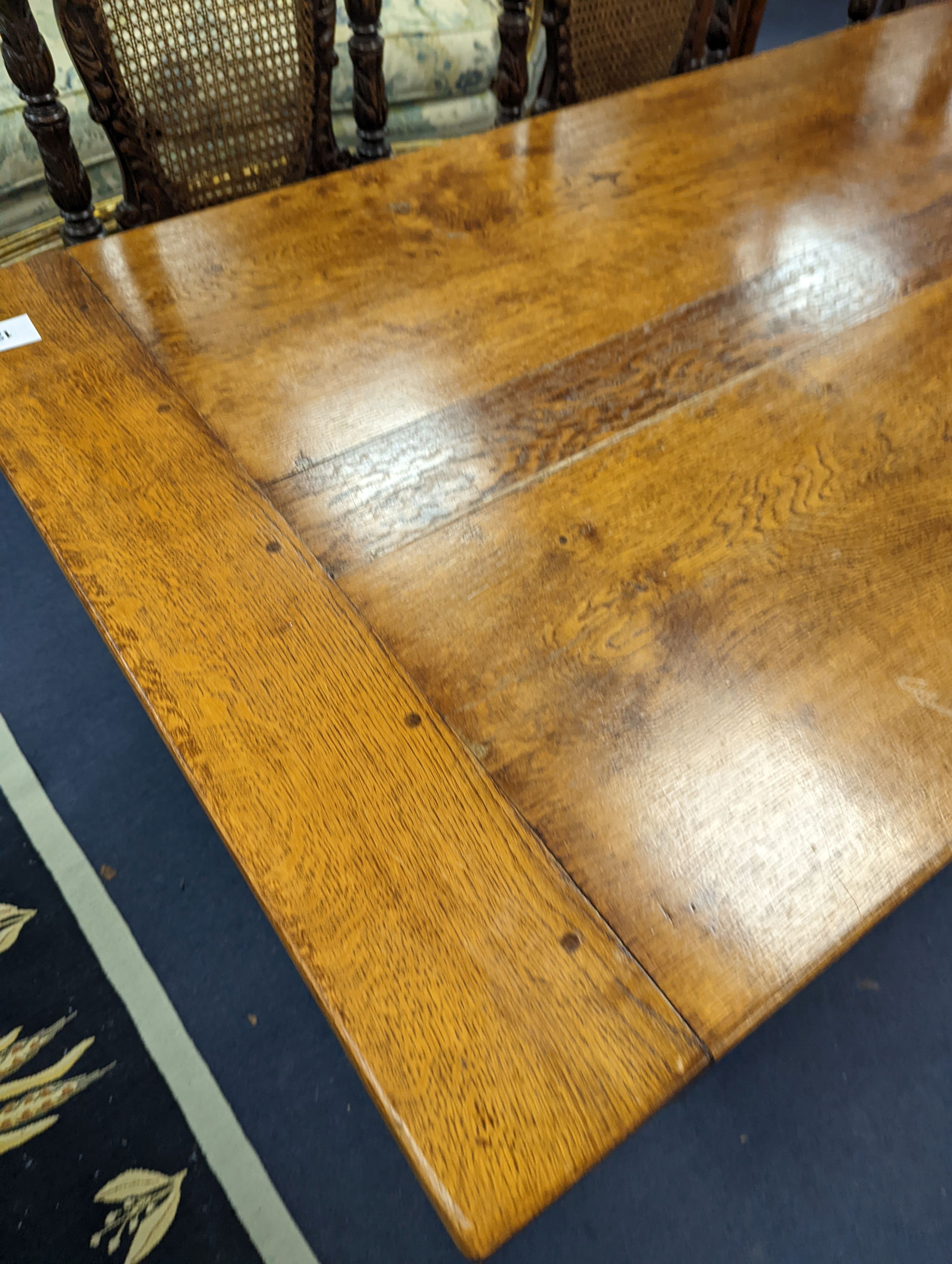 An 18th century style rectangular oak refectory dining table with central stretcher, length 230cm, depth 80cm, height 74cm